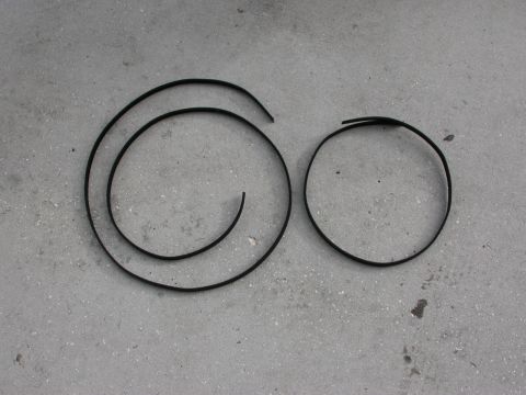 1968 Mercury Cougar - Two rubber trim pieces are laid out on a concrete floor.