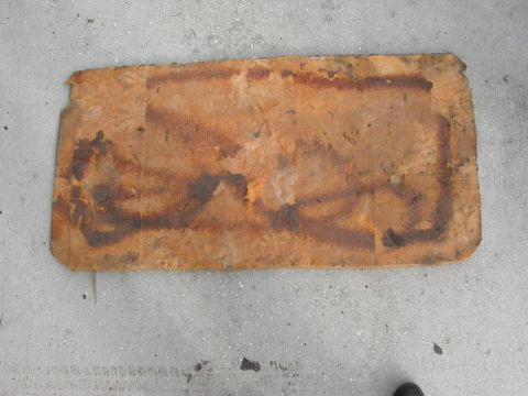 1968 Mercury Cougar - This appears to be a piece of old insulation material, possibly from a vehicle, with some dark markings on its surface.