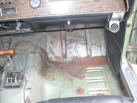 1968 Mercury Cougar - Interior floor of a 1968 Mercury Cougar shows significant rust damage and the automatic shifter.