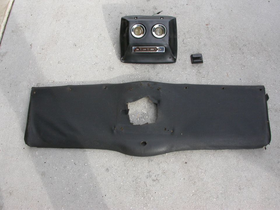 Black dashboard panel with two gauges and radio, and a separate lower panel