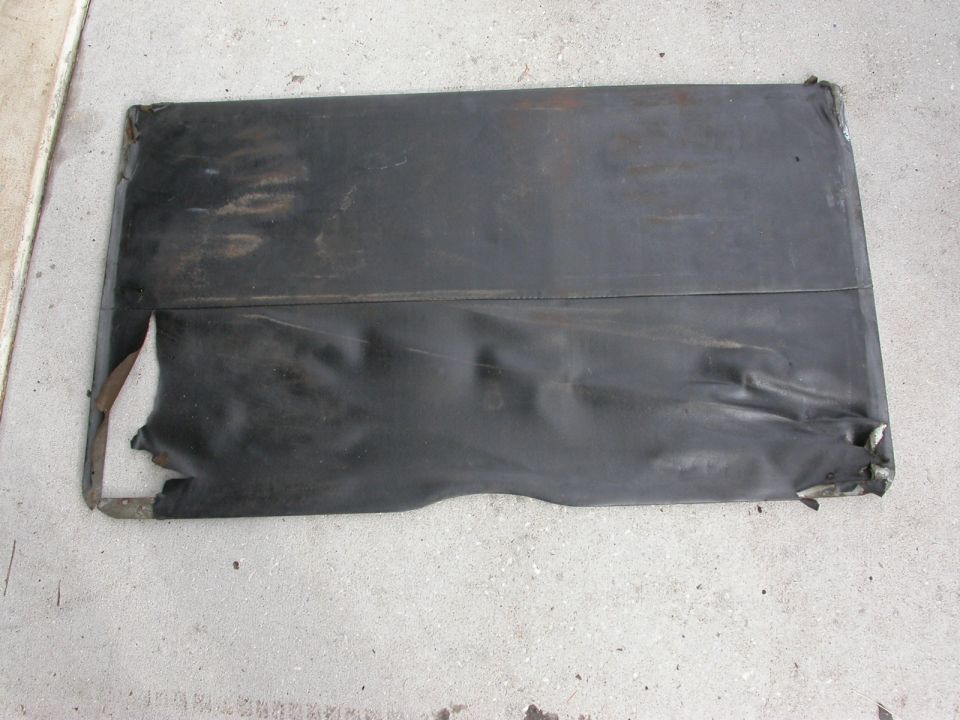 Black vinyl convertible top frame with torn edges