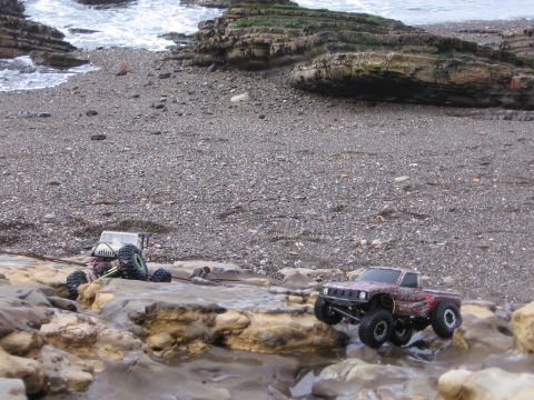 1993 Toyota 4Runner - Remote-controlled trucks tackle a challenging rocky terrain near the ocean.