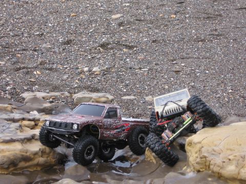 1993 Toyota 4Runner - RC rock crawlers tackle a challenging, wet, and rocky obstacle course.