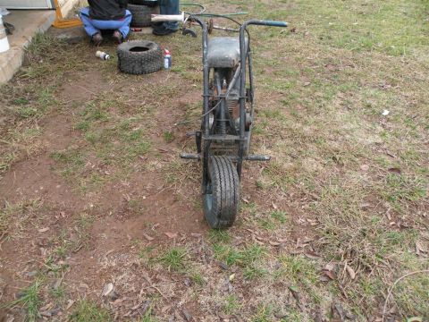 1901 Ford Bronco - A weathered mini bike is parked outdoors on a patch of grass, awaiting restoration.
