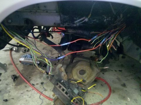 1986 Ford Mustang - This image shows a complex and messy vehicle wiring harness, likely undergoing repair or modification.