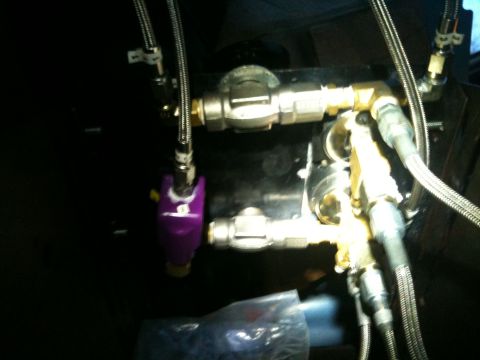 1989 Ford Bronco - This image shows a close-up of an air suspension system's valve block, various metal fittings and a purple solenoid.