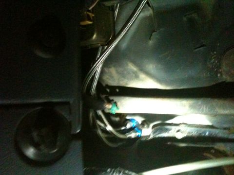 1989 Ford Bronco - Close-up view of the undercarriage, showing fuel lines and electrical wiring.