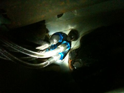 1989 Ford Bronco - Braided fuel lines with blue fittings are visible, likely part of an engine or fuel system.
