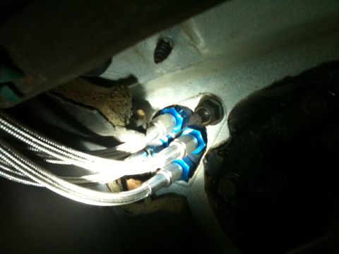 1989 Ford Bronco - Braided fuel lines are connected to a blue fitting, likely part of a fuel system upgrade.
