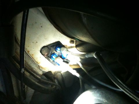 1989 Ford Bronco - Close-up of a fuel filter housing with blue fittings and braided hoses.