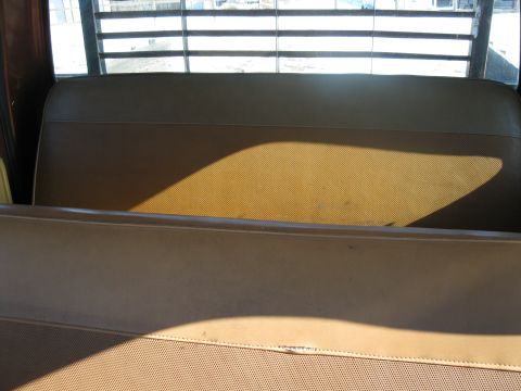 1977 Ford F-250 - Interior view of a truck cab, showing the bench seat and rear window with horizontal slats.