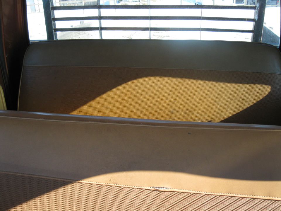 Brown truck interior with slatted rear window and bench seat