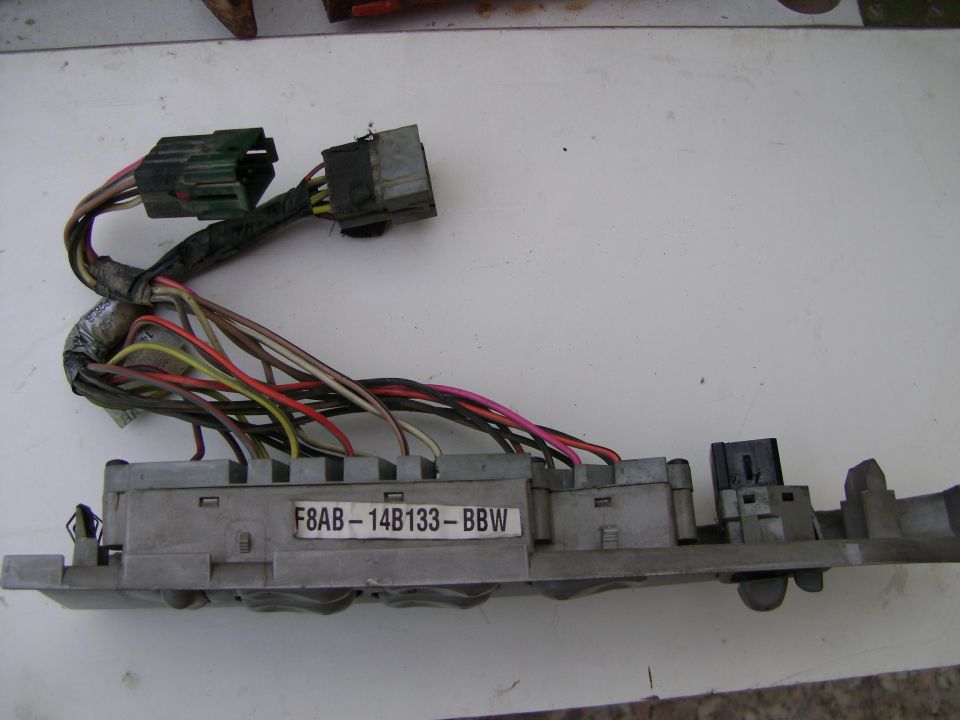 Fuse box with part number F8AB-14B133-BBW and wiring harness