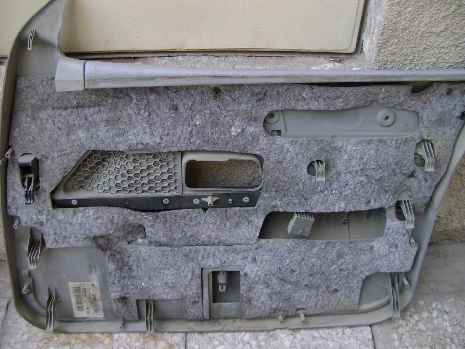 Interior of a car door panel with insulation and mounting points visible. Label reads 'SUPERMOTORS.net'