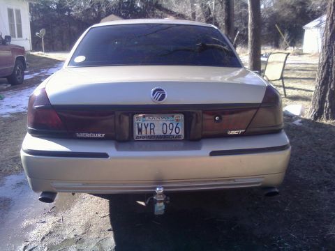 2000 Mercury Grand Marquis - Rear view of a silver 2000 Mercury Grand Marquis parked outdoors.
