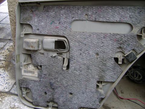 1998 Ford Crown Victoria - Close-up of a car's interior door panel, revealing insulation and a visible label indicating '2000 Ford Rear Left'.