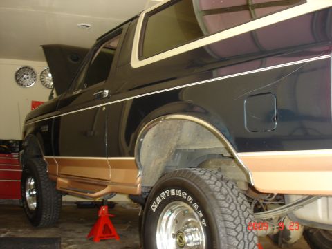 1995 Ford Bronco - This Ford Bronco is being worked on in a garage, supported by red jack stands.