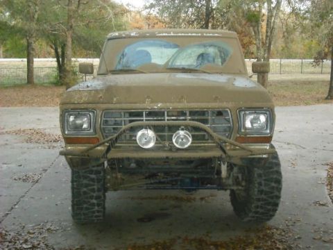1979 Ford Bronco - This 1979 Ford Bronco is heavily covered in mud, obscuring details but retaining its iconic front-end.