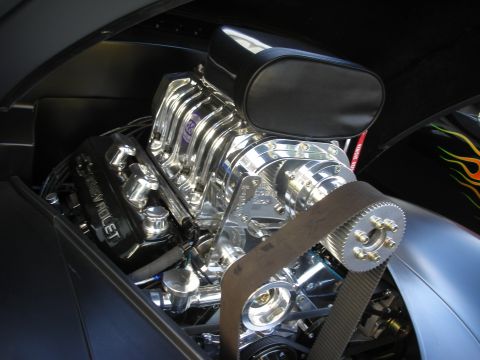 1992 Ford Crown Victoria - Close-up of a highly polished V8 engine with a prominent supercharger and flame decals on the fender.