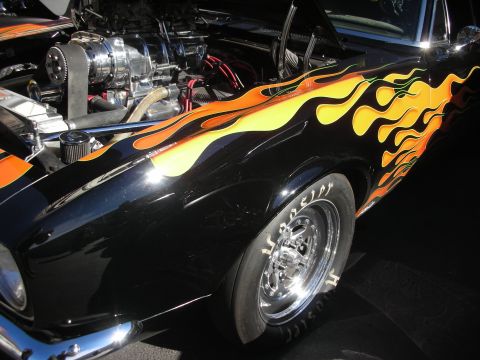 1992 Ford Crown Victoria - A black hot rod with a prominent supercharger and custom flame paint job is shown from the front quarter panel.