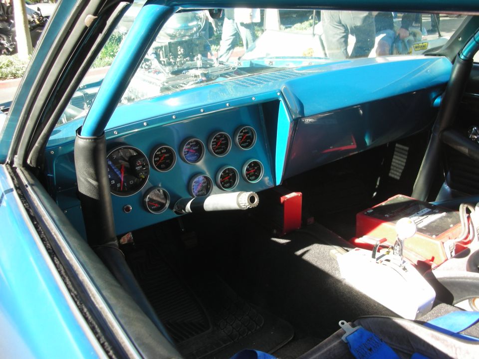 Blue interior with multiple gauges and racing shifter