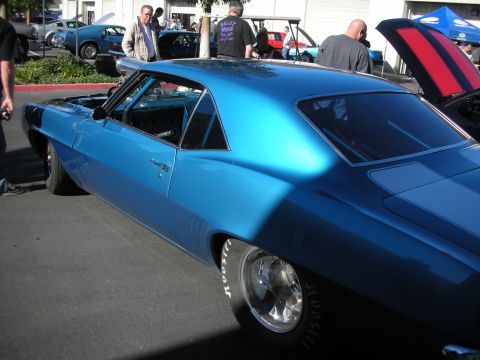 1992 Ford Crown Victoria - A blue 1969 Chevrolet Camaro is parked at an outdoor car show with other vehicles visible.