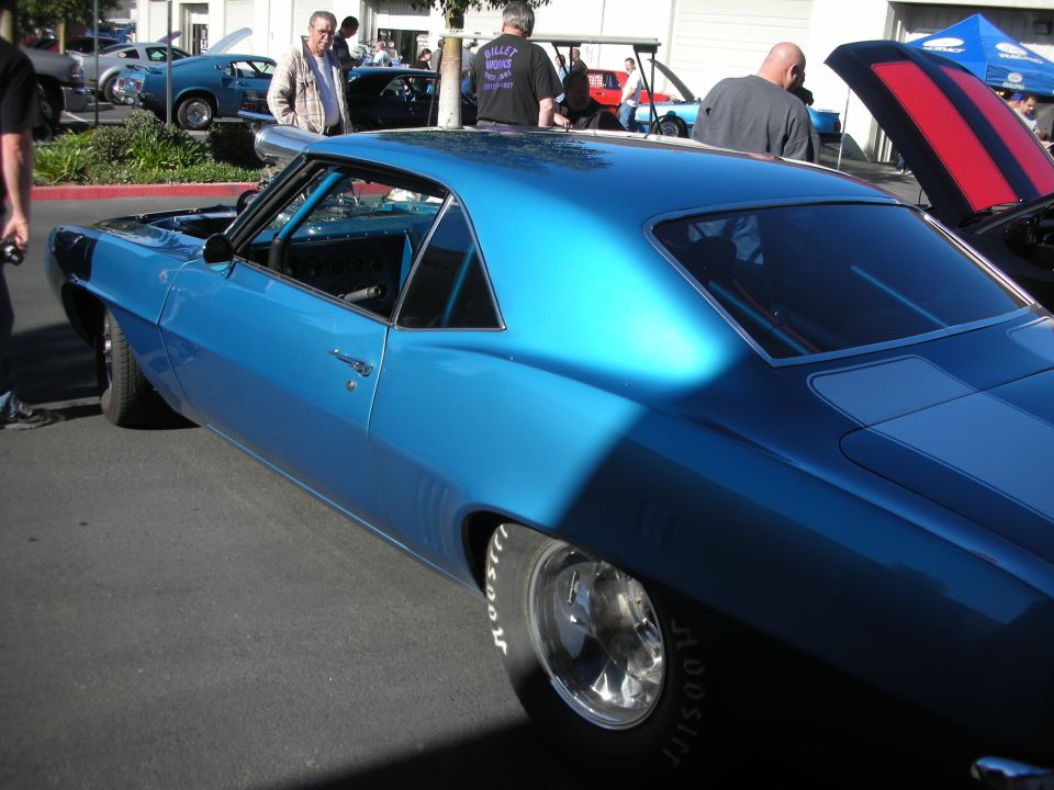 Blue 1969 Chevrolet Camaro with racing slicks and silver stripes