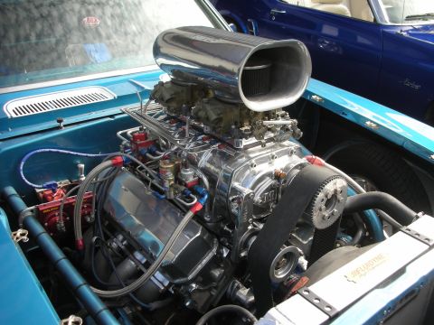 1992 Ford Crown Victoria - A highly customized engine with a prominent chrome supercharger and dual carburetors is visible, with another blue vehicle in the backgroun…