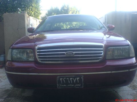 1998 Ford Crown Victoria - This Ford Crown Victoria features a distinctive chrome grille and a front license plate with foreign characters.