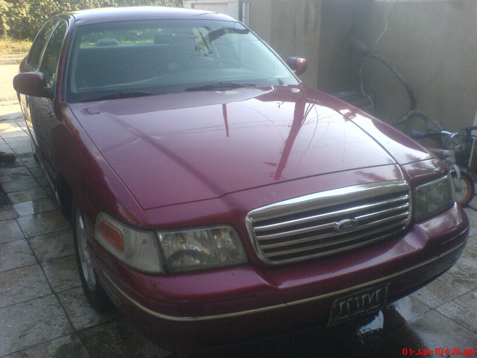 Maroon 1998 Ford Crown Victoria front grille and headlights