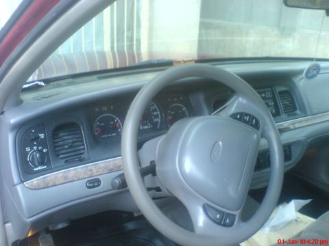 1998 Ford Crown Victoria - The interior of a 1998 Ford Crown Victoria, the dashboard, steering wheel, and instrument cluster.