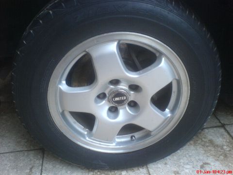 1998 Ford Crown Victoria - A close-up view of a vehicle's wheel and tire, a 'LIMITED' brand center cap.
