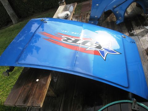 1986 Ford Bronco - A blue hood with racing decals is shown, likely a replacement part.