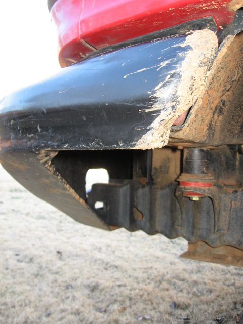 1995 Ford F-150 - Mud-covered truck bumper and frame details are visible in this close-up shot.