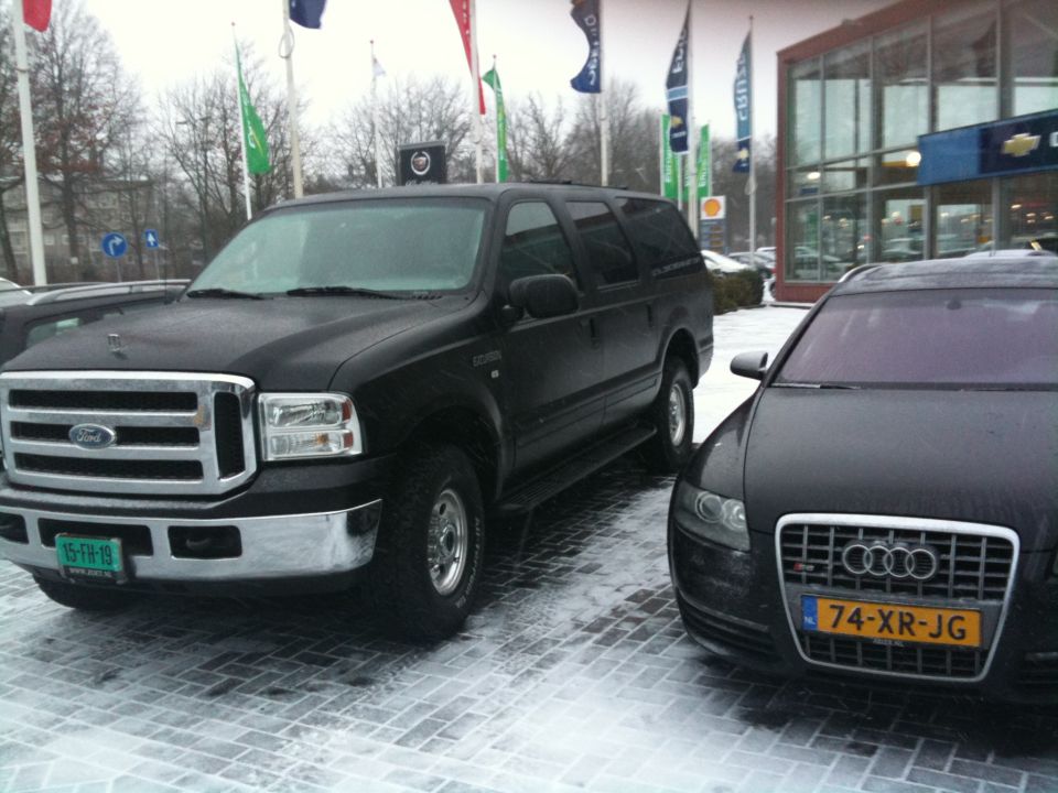 Black Ford Excursion parked next to an Audi. The Excursion has a Dutch license plate