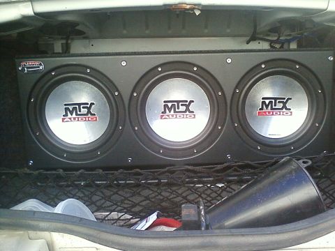 1990 Ford Bronco - Triple MTX Audio subwoofers installed in a car's cargo area.