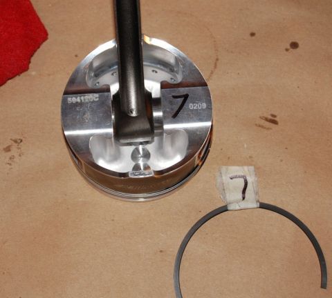 2007 Ford Mustang - A piston and connecting rod assembly is shown next to a piston ring. The piston is marked with the number 7 and part number 594135C.