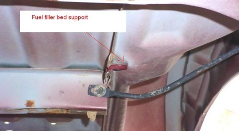 2007 Ford Mustang - Close-up view of a fuel filler bed support bracket and associated hardware.