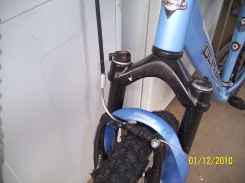 1993 Ford Probe - Close-up view of a bicycle's front suspension fork, fender, and tire.