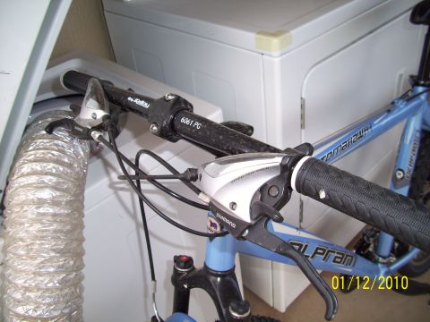 1993 Ford Probe - Close-up of bicycle handlebars and frame, with a dryer in the background.