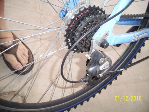 1993 Ford Probe - Close-up of a bicycle's rear derailleur and cassette, with the 'ALTUS' brand name clearly visible on the derailleur.