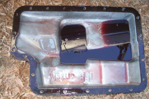 1992 Ford C-350 (Centurion Conversions) - Transmission pan with dark fluid, showing signs of wear and residue.