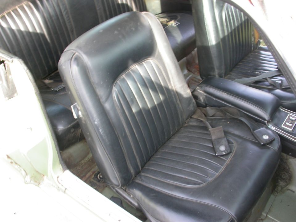 1968 Mercury Cougar interior with black vinyl seats and seatbelts