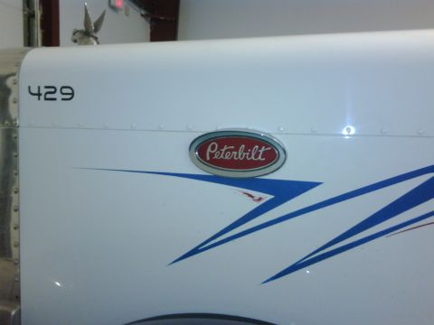 2003 Peterbilt 379 - Peterbilt 379 side panel shows the brand badge and custom graphics, with unit number 429.