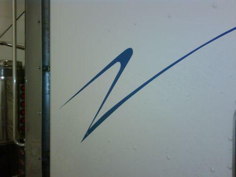 2003 Peterbilt 379 - Close-up of a white truck's side panel a blue abstract graphic and a Supermotors.net watermark.