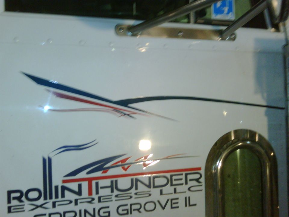 White truck door with blue, red, and black graphics and text 'ROLLIN THUNDER EXPRESS LLC SPRING GROVE IL'
