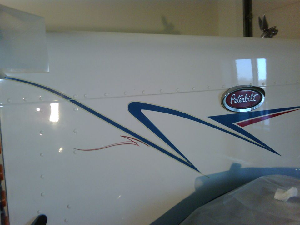 Peterbilt truck side with blue and red graphics and Peterbilt badge
