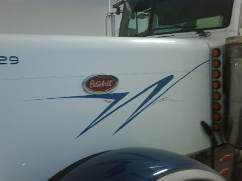 2003 Peterbilt 379 - Close-up of a 2003 Peterbilt 379 truck's side fender and door panel.