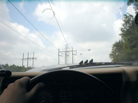1983 Ford Bronco - Driving down the road with power lines visible through the windshield.