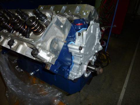 1971 Ford Mustang - Close-up of a blue engine block with a silver timing cover, likely undergoing assembly or repair.